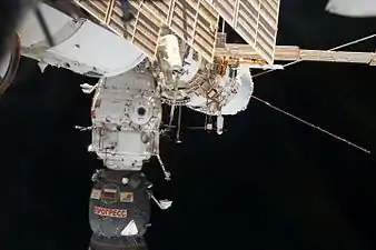 Cosmonaut Alexander Misurkin (top center), participates in a session of extravehicular activity (EVA) near Pirs module.