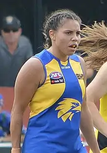 Female athlete in an Australian rules football game