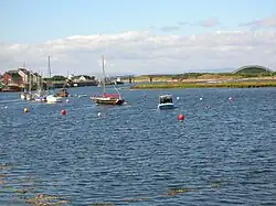 Looking seaward towards the Scottish Maritime Museum's pontoons, with the closed 'Big Idea' building and footbridge in the background.