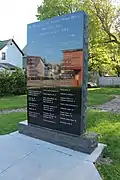 The granite memorial in 2019 listing the names of the victims