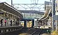 The Nambu Line platforms viewed from a level crossing to the east of the station, January 2014