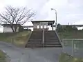 A broad flight of steps up the embankment to the station building.