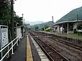 View of the platforms and tracks. Note the level crossing.