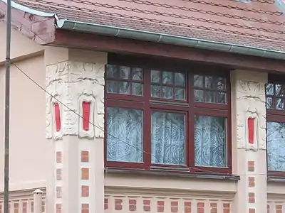 Detail of the masks flanking the windows