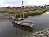 The replica of James Caird afloat in the river next to the museum.