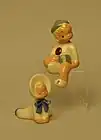 Jane Fauntz baby and sitting boy figurines.