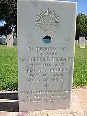 a colour photograph of an engraved marble headstone