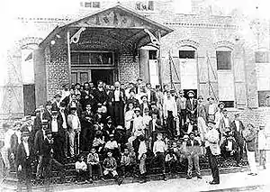 Jose Marti (center) with cigar workers on the steps of V. M. Ybor's cigar factory, 1893