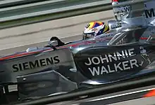 McLaren had no title sponsor in 2006 but the Johnnie Walker logo was used on the side pods, as evidenced by Juan Pablo Montoya's McLaren MP4-21 at the 2006 United States Grand Prix. From this year onwards, the team has also used a highly reflective version of its silver livery.