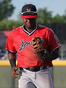 A baseball player in red and gray