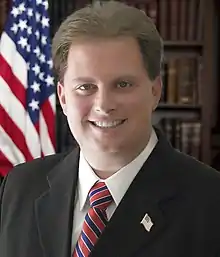 Iconic American Flag and Law Bookshelf showing Congressional Candidate Justin Lamar Sternad.