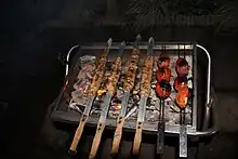 Kabab koobideh and tomato grilling over barbecue grill