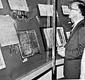 A man stands in front of the imperial documents and Judenschreinsbuch (Jewish shrine book) of the Cologne Laurenz parish.