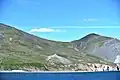 Cape Dezhnev (Chukotka, Russia) with lighthouse (Dezhnew Monument) and abandoned village Naukan