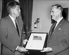 Luke E. Hart standing with President John F. Kennedy in 1961