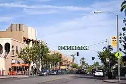 A neon sign hangs over Adams Avenue, the main thoroughfare in Kensington.