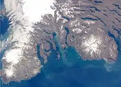 The southern part of the Kerguelen Islands, with Mont Ross at right (white spot, top of image is north) and on the left, the Glacier Cook (white spot) and the Peninsula Rallier du Baty.