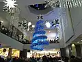 A Christmas Tree light show being held in the mall's centre court on November 14, 2009. Cookies by George, Cinnzeo, and Second Cup (closed) can be seen.