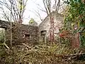 Ruins of an old mill sit adjacent to the cemetery, once powered by the creek.