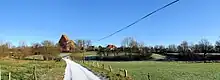 green countryside; church in background