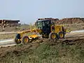 Grader cleaning and leveling