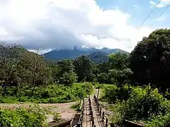 The bridge across Bavali river. The scenic cloudy hills in background