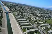 Springtime overnight rains runoff into La Ballona Creek in this picture taken from a kite. Mar Vista Gardens can be seen on the right as a cleanup crew works under the Inglewood Blvd. overpass.