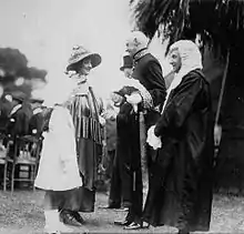 1921 - Lady Weigall, wife of the Governor of South Australia, accompanied by her daughter Priscilla greeting Sir George Murray, Lieutenant Governor and Justice Angas Parsons at a garden party held in the grounds of Government House, Adelaide.