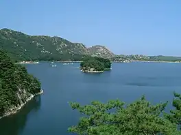 Lake with small islands lined by mountains