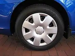 Plastic hubcap covering a steel wheel bears the automaker's logo