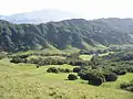 View east from Rocky Ridge toward Las Trampas Ridge. Visitor parking lot is amid the trees at the bottom of the valley. Mount Diablo is in the hazy distance