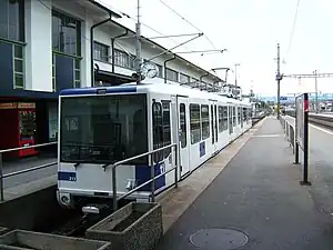 Blue and white metro car at platform