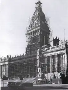 B&W photograph of a scaffolding-covered Town Hall undergoing cleaning