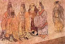 "In this mural foreign ambassadors are being received at court. The two elegantly clad figures on the right are from Korea, the bare-headed, large-nosed figure in the centre is an envoy from the west. Mural from Li Xian's tomb, Qianling, Shaanxi, 706."