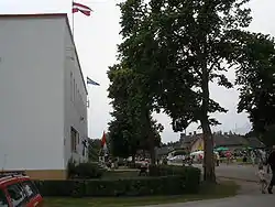 Livonian culture centre in Mazirbe with flags on display during annual meeting.