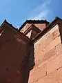 Southeastern façade details showing the circular shield pattern molding on the cornice and an inscription