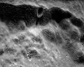 Small crater in the wall of Lobachevskiy with distinct flow lobes