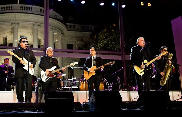 A band is performing at a stage in front of the White House