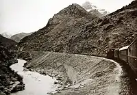 Train going along a gorge through a winding route somewhere in Iraq.