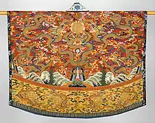 Daoist Robe, 17th Century'Robe embroidered with 5 dragons hovering over a landscape of mountains and ocean, likely worn by a Taoist priest during ceremonies.