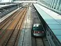 A Tung Chung line CAF-train at Sunny Bay station as viewed from the footbridge