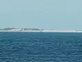 Wreck of the MV Sygna as seen from southern end of the beach, approximately 8.8 km (5.5 mi) to the south-west