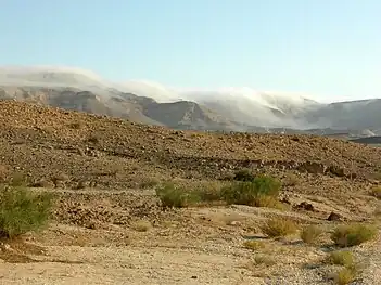 Mist flowing over the northern rim of Makhtesh Gadol