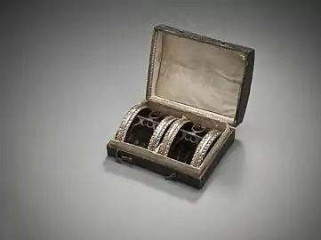 Man's shoe buckles with case.  Paste stones with gilded-copper-alloy trim on silver and steel, France, c. 1785. LACMA M.2007.211.829a-b.