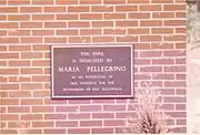 Maria Pellegrino dedication plaque at park entrance.