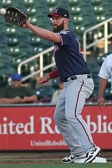 A baseball player in navy and gray