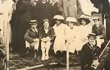 Dudley Ward, Rupert Brooke, Margery Olivier, Dolly Rose, Brynhild Olivier and Edwin Pye, seated on the bank of the Cam river during May Week 1911