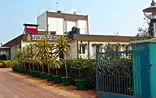 A one storied building with decorative plants and landscaping around it