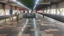 Multiple passengers wait on the only platform