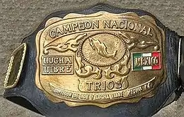 The front plate of the championship in gold with lettering raised to read "Campeon Nacional" and "Trios" underneath